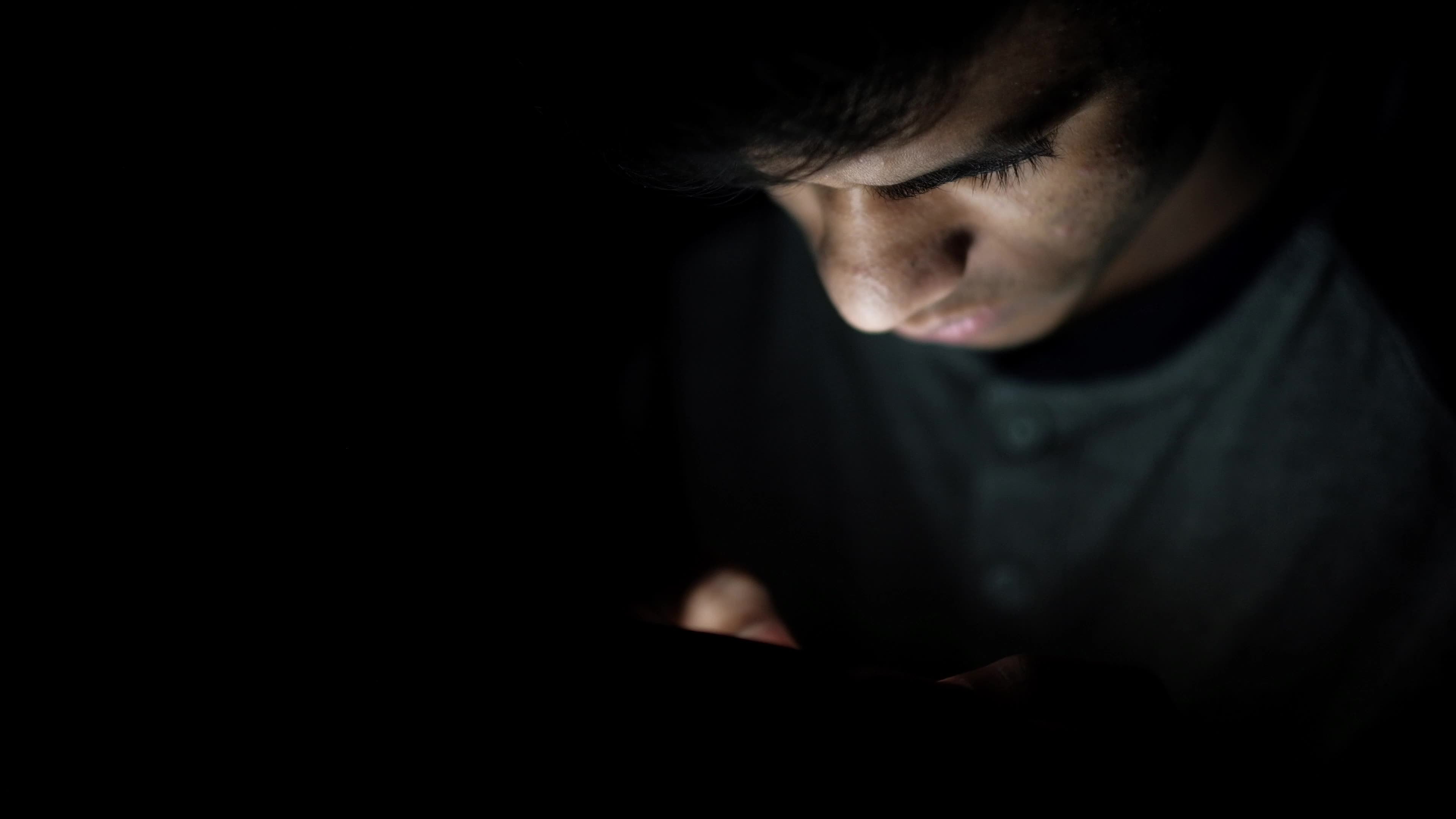 isolated man is looking at his phone in the dark 22412119 Stock Video