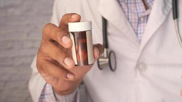 young doctor holding pill container with copy space video
