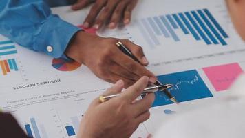 Financial analysts analyze business financial reports on a digital tablet planning investment project during a discussion at a meeting of corporate showing the results of their successful teamwork. video