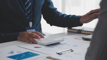 Financial analysts analyze business financial reports on a digital tablet planning investment project during a discussion at a meeting of corporate showing the results of their successful teamwork. video