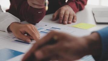 Financial analysts analyze business financial reports on a digital tablet planning investment project during a discussion at a meeting of corporate showing the results of their successful teamwork. video