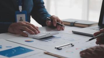 Financial analysts analyze business financial reports on a digital tablet planning investment project during a discussion at a meeting of corporate showing the results of their successful teamwork. video