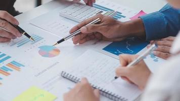Financial analysts analyze business financial reports on a digital tablet planning investment project during a discussion at a meeting of corporate showing the results of their successful teamwork. video