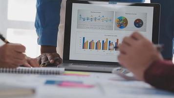 Financial analysts analyze business financial reports on a digital tablet planning investment project during a discussion at a meeting of corporate showing the results of their successful teamwork. video