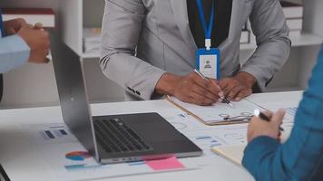 Financial analysts analyze business financial reports on a digital tablet planning investment project during a discussion at a meeting of corporate showing the results of their successful teamwork. video