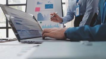 Financial analysts analyze business financial reports on a digital tablet planning investment project during a discussion at a meeting of corporate showing the results of their successful teamwork. video