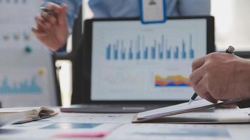 Financial analysts analyze business financial reports on a digital tablet planning investment project during a discussion at a meeting of corporate showing the results of their successful teamwork. video