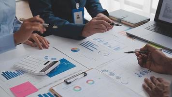 Financial analysts analyze business financial reports on a digital tablet planning investment project during a discussion at a meeting of corporate showing the results of their successful teamwork. video