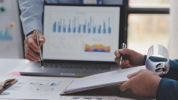 Financial analysts analyze business financial reports on a digital tablet planning investment project during a discussion at a meeting of corporate showing the results of their successful teamwork. video