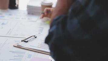 Financial analysts analyze business financial reports on a digital tablet planning investment project during a discussion at a meeting of corporate showing the results of their successful teamwork. video
