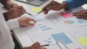 Financial analysts analyze business financial reports on a digital tablet planning investment project during a discussion at a meeting of corporate showing the results of their successful teamwork. video