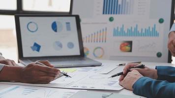 Financial analysts analyze business financial reports on a digital tablet planning investment project during a discussion at a meeting of corporate showing the results of their successful teamwork. video
