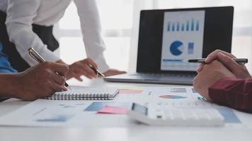 Financial analysts analyze business financial reports on a digital tablet planning investment project during a discussion at a meeting of corporate showing the results of their successful teamwork. video