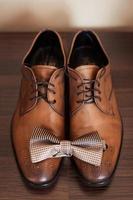 Mans brown leather shoes with bow tie for evening event photo