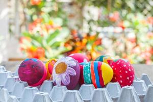 easter egg in egg box  on wood photo