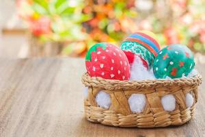 easter egg in basket on wood photo