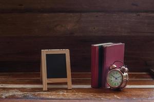 still life alarm clock on old book photo