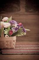 still life flower in basket on old wood photo