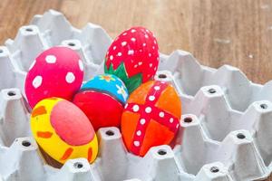 easter egg in basket on wood photo