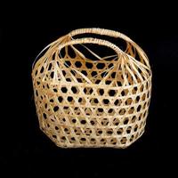 Wicker round bamboo basket on black background. photo