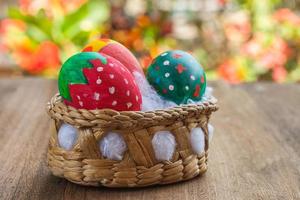 easter egg in basket on wood photo