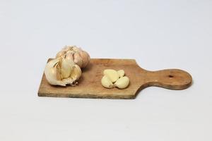 isolated garlic on a cutting board on a white background photo