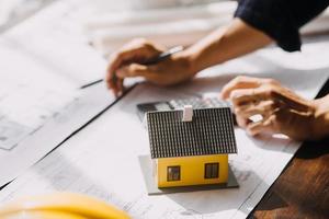 Two business man construction site engineer. Engineering objects on workplace with partners interacting on background photo