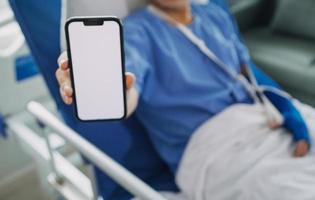 Man with broken arm in cast lying on bed in hospital. The emergency center treatment is plaster and hangs with sling for a further cure in an orthopedic clinic. Patient pain from accident injury. photo