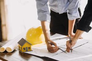Two business man construction site engineer. Engineering objects on workplace with partners interacting on background photo