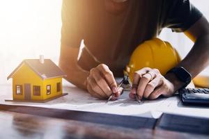 Two business man construction site engineer. Engineering objects on workplace with partners interacting on background photo