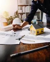 Two business man construction site engineer. Engineering objects on workplace with partners interacting on background photo