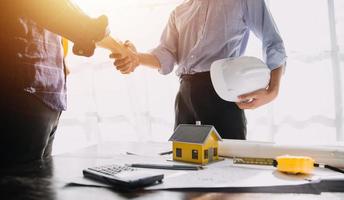 Two business man construction site engineer. Engineering objects on workplace with partners interacting on background photo
