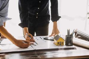 Two business man construction site engineer. Engineering objects on workplace with partners interacting on background photo