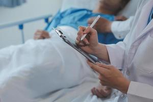 Women Asian doctors hold the patient hand and encourage and provide medical advice While checking the patient health in bed. Concept of Care and compassion, antenatal care, Threatened abortion photo