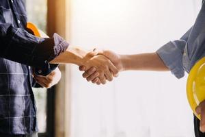 Two business man construction site engineer. Engineering objects on workplace with partners interacting on background photo