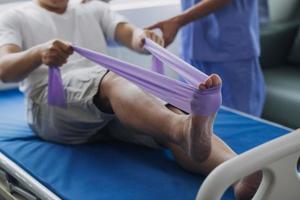 Patient doing some special exercises under supervision in a room photo