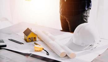 Two business man construction site engineer. Engineering objects on workplace with partners interacting on background photo