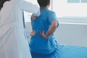 Physiotherapist working with patient in clinic, closeup photo