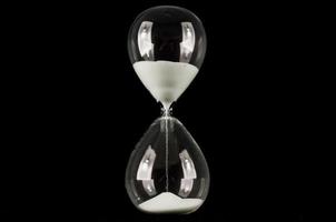 Hourglass on dark background photo