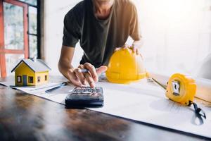 Two business man construction site engineer. Engineering objects on workplace with partners interacting on background photo