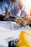 Two business man construction site engineer. Engineering objects on workplace with partners interacting on background photo