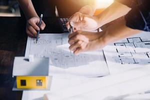 Two business man construction site engineer. Engineering objects on workplace with partners interacting on background photo