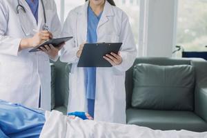 Man with broken arm in cast lying on bed in hospital. The emergency center treatment is plaster and hangs with sling for a further cure in an orthopedic clinic. Patient pain from accident injury. photo