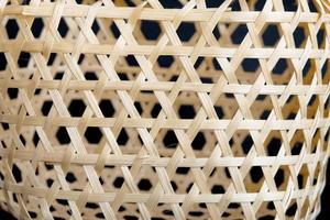 Wicker round bamboo basket on black background. photo