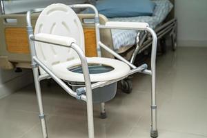 Flush toilet and shower chair in bathroom for old elder people. photo