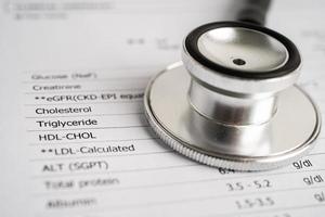 Stethoscope on blood test report, egfr, cholesterol, triglyceride, hdl, ldl. photo