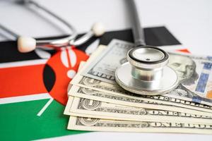 Black stethoscope with US dollar banknotes Kenya flag background, Business and finance concept. photo