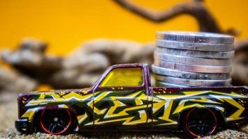 minahasa, Indonesia  January 2023, Toy car carrying coins photo