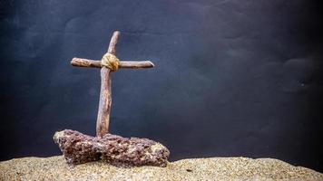 wooden cross on black background photo