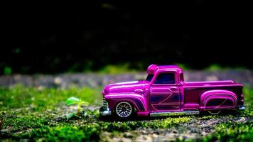 South Minahasa, Indonesia  January 2023, a toy car on a mossy floor that looks like grass photo